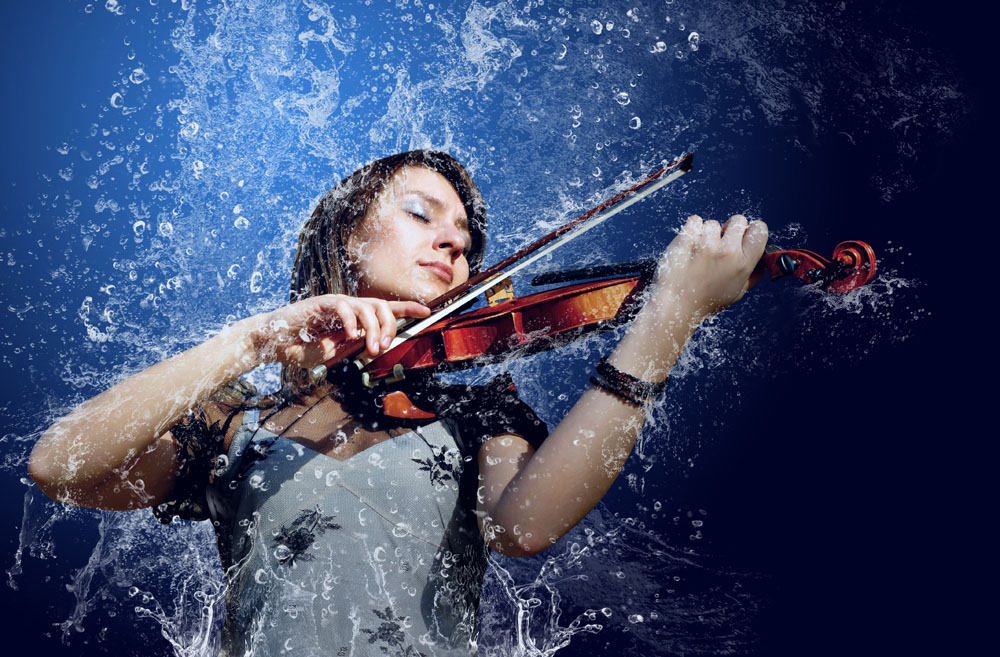 A girl playing the violin under water